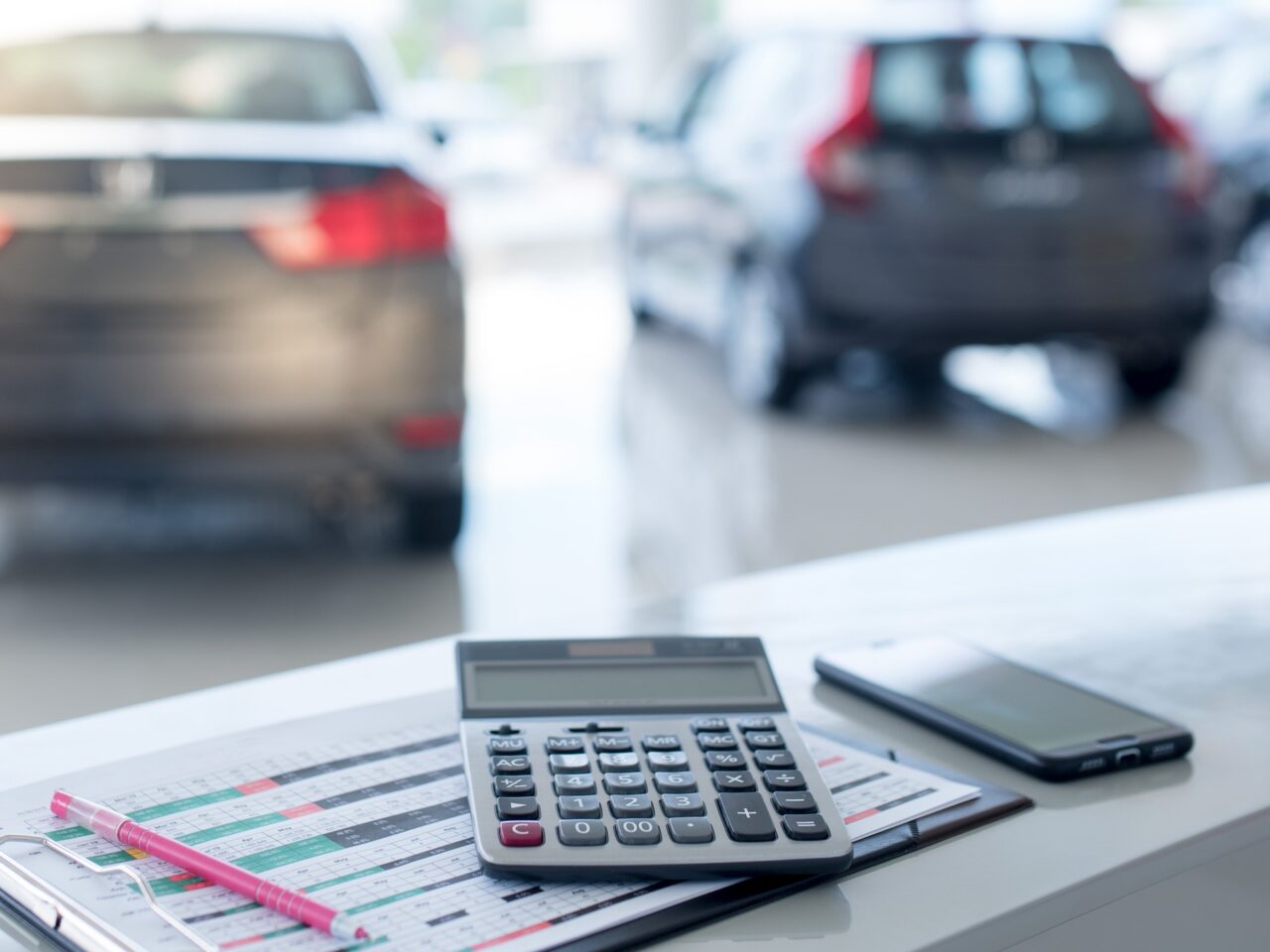 Beautiful modern showrooms with cars that sell background as new cars in stock blur for the four-wheeled tire industry, set at a large warehouse.